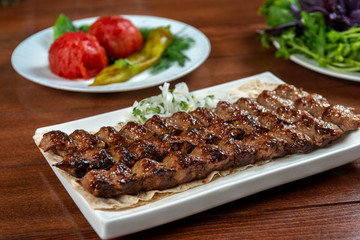 Fast food. Eastern food. Shish kebab, lyulya-kebab. Dishes of oriental cuisine lying in plte and...