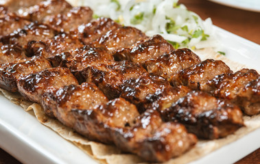 Fast food. Eastern food. Shish kebab, lyulya-kebab. Dishes of oriental cuisine lying in plte and...