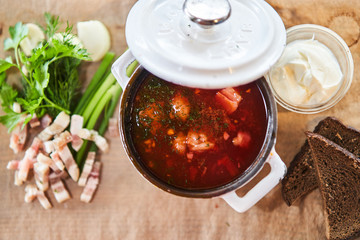 pan with borscht on a wooden supply. National cuisine
