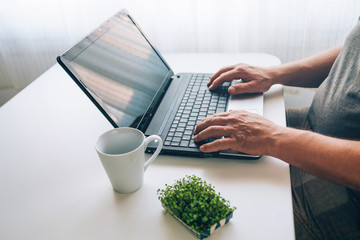 Old man shopping online with credit card. Older society adapting to news technologies.