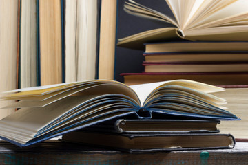 Naklejka premium Open book, hardback books on wooden table. Back to school. Copy space