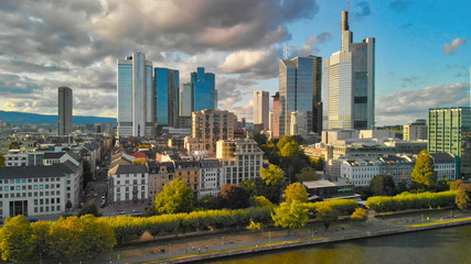 Fototapeta na wymiar Aerial flying along the futuristic skyline the business and financial centre of Frankfurt am Main, sunset view from drone