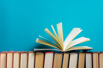 Open book, hardback books on wooden table. Back to school. Copy space