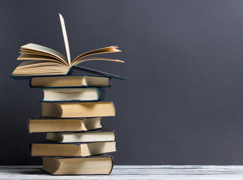 Open book, hardback books on wooden table. Back to school. Copy space