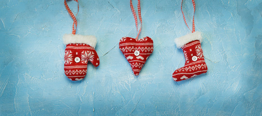 Christmas decorations hanging on a blue background. - 290691906