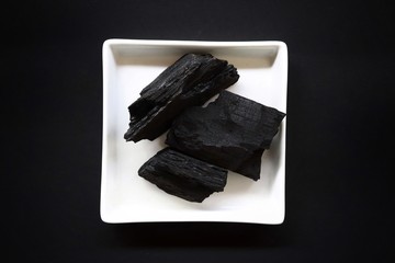 carbon and bamboo charcoal soap on wood background