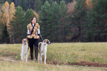 Portrait of a beautiful girl hunter with dogs
