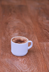 Coffee cup top view on old wooden