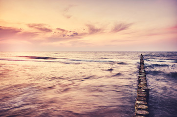 Scenic seascape sunset, color toning applied, long exposure picture.
