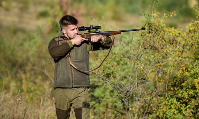 Hunter hold rifle. Hunting is brutal masculine hobby. Hunting and trapping seasons. Bearded serious hunter spend leisure hunting. Man brutal unshaved gamekeeper nature background. Hunting permit