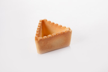 Triangular tartlet made of unleavened dough for filling with different fillings. The concept of cooking snacks. Photo on a white background. Isolated object. View from above.