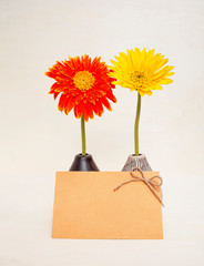 Red and yellow flower in design vase with blank yellow card, greeting card idea