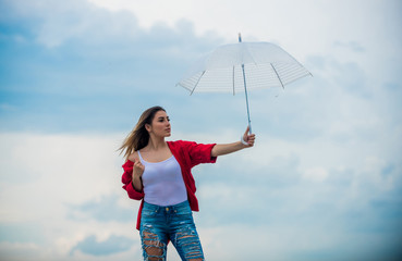 Wind of change. Pretty woman with light umbrella. Rainbow umbrella. Rainy weather. Good mood. Good...