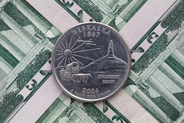 Fototapeta na wymiar Symmetric composition of US dollar bills and a quarter of Nebraska.