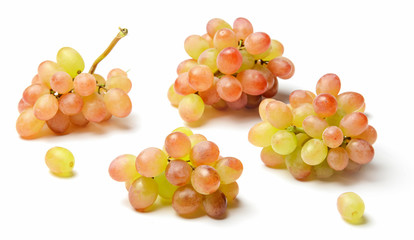 Several little clusters of raisins grapes isolated on white. Bright saturated color of red and yellow. Side view.