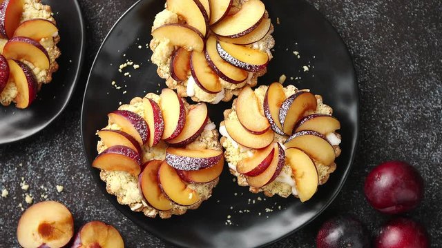 Delicious homemade mini tarts with fresh sliced plum fruit