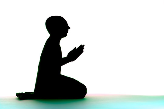 Modern spiritual lifestyle. Monk praying. Zen Buddhist statue silhouette.