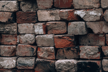 Old bricks. Photo background with old brickwork closeup. Vintage darkened bricks