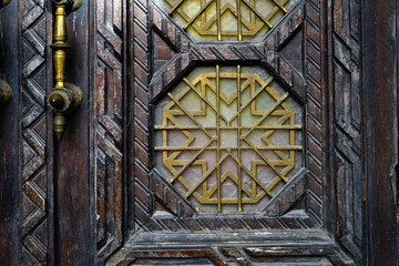     Decorative element on the stack, and wooden doors. Entrance to the Synagogue.   