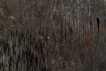 Fototapeta premium Old wooden dark gray texture background. Vintage texture. Surface with scuffs, lines and black spots. Black and brown colors. Background for text or design