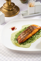 Grilled fish and spinach sauce, food close-up