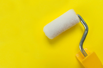 Cushion for paint on a yellow background. Copy space