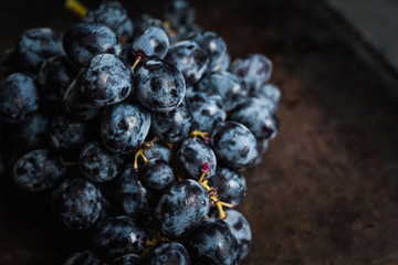 Ripe grape on the rustic background. Selective focus. Shallow depth of field.