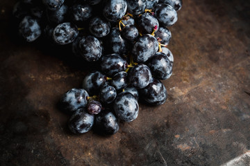 Ripe grape on the rustic background. Selective focus. Shallow depth of field.