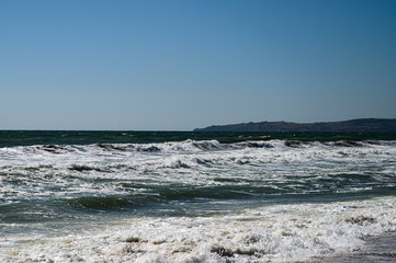 Fototapeta na wymiar Black Sea. Summer storm. Waves lapping at the sandy beach.
