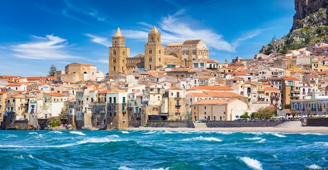 Panoramic view from sea to sandy beach in Cefalu, town in Italian Metropolitan City of Palermo located on Tyrrhenian coast of Sicily, Italy.