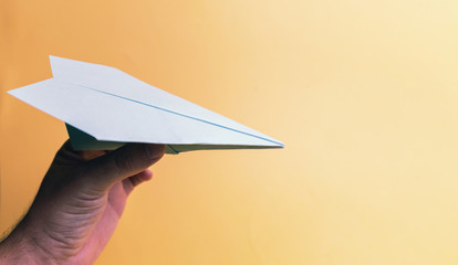 paper airplane on a yellow background