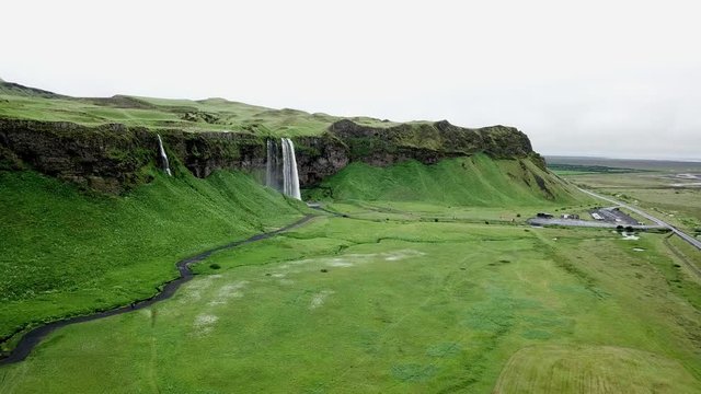 4K Aerial Drone footage from the sky of Iceland waterfall valley in the southern region. Beautiful green Icelandic landscape