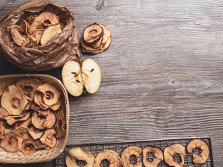 Tasty apple chips on wooden table, healthy vegan vegetarian fruit snack or ingredient for cooking