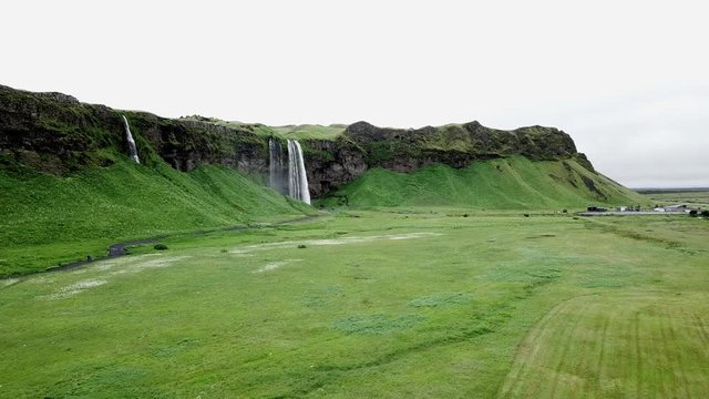 4K Aerial Drone footage from the sky of Iceland waterfall valley in the southern region. Beautiful green Icelandic landscape