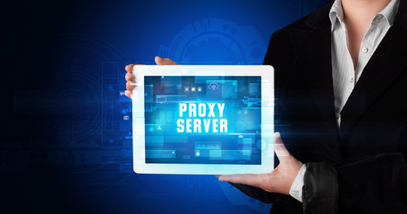 Young business person working on tablet and shows the digital sign: PROXY SERVER