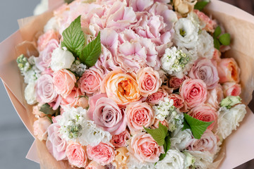 Large beautiful bouquet of mixed flowers in woman hand. Floral shop concept . Handsome fresh bouquet. Flowers delivery.