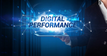 Young business person working on tablet and shows the inscription: DIGITAL PERFORMANCE