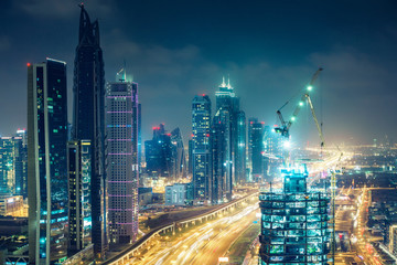 Obraz na płótnie Canvas Downtown Dubai at night. Elevated view on highways and skyscrapers.