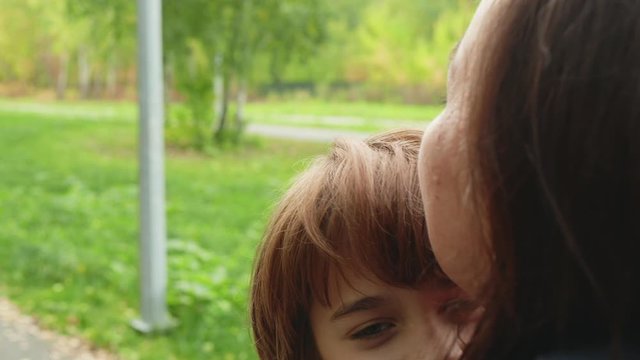 Close Up Face Smiling Boy Teenager Hugging Mom Outdoor. Portrait Teenager Boy Embracing Mother At Meeting. Son And Mother Concept. Happy Family Relationships