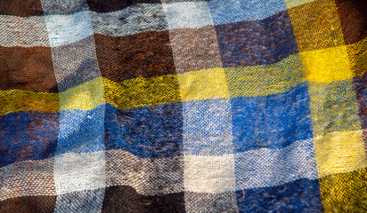 A fragment of a wool plaid blanket.