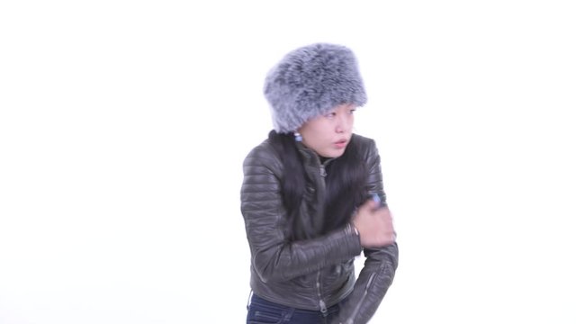 Beautiful Asian woman feeling cold and shivering