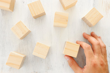 business concept of man hand arranging wooden blocks. mock up or template