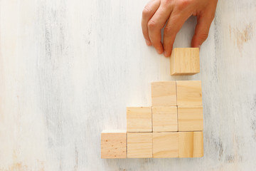 business concept of man hand arranging wooden blocks. mock up or template