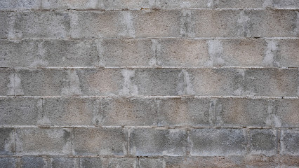 Cement blocks wall. Modern grey brick wall background. Textured concrete backdrop. Temporary fence at a construction site. 