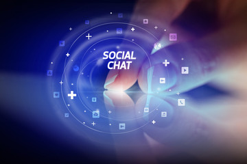 Finger touching tablet with social media icons and SOCIAL CHAT