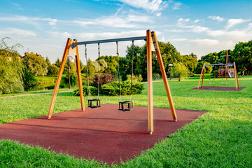 wooden children's swing in the traditional Russian style in the park