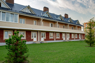  beautiful rural village with two-story houses and trees on a summer day