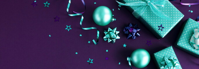 Banner christmas or new year decorations background in mint colors on dark violet purple color background with empty copy space for text. holiday and celebration concept for postcard . top view 