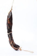 The jerky is tied with twine. Portion pieces of jerky. Isolated object Copy space. Macro photo.
