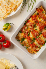 Baked pancakes with chicken in tomato sauce.